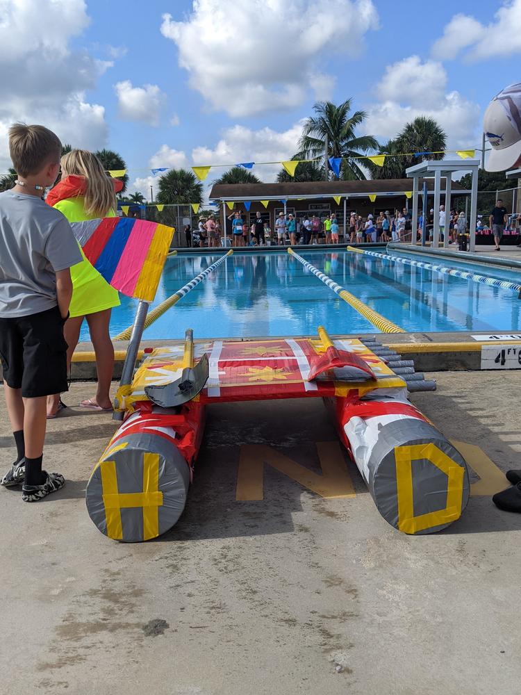 Students build cardboard boats and race them