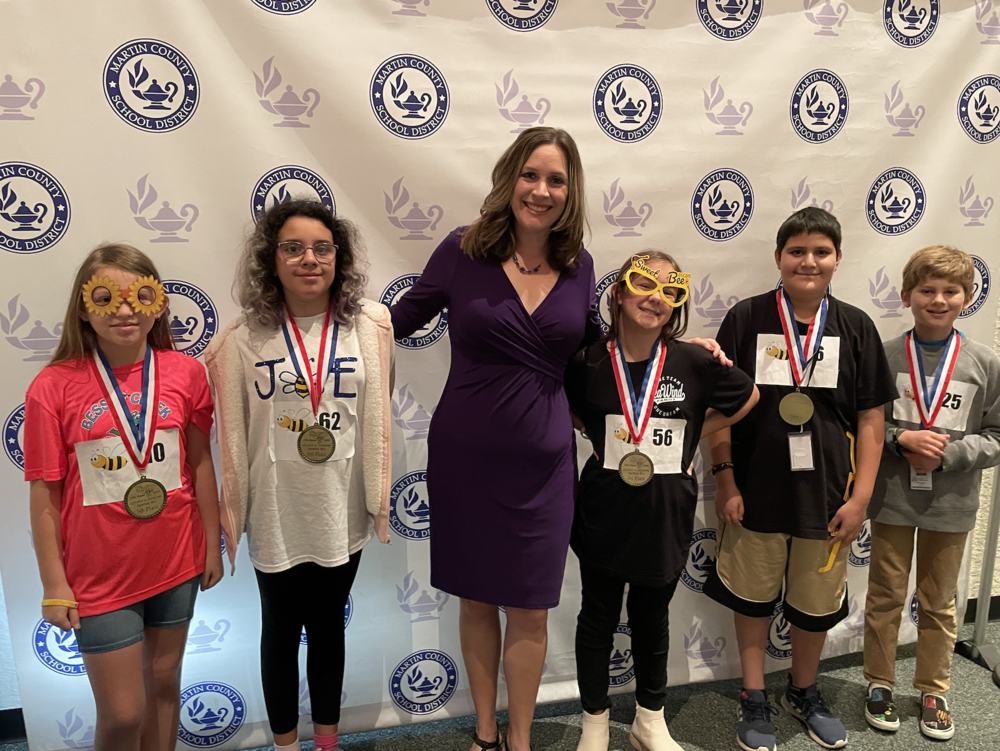 Top 5 Finalists of Spelling Bee pose for group picture with enunciator