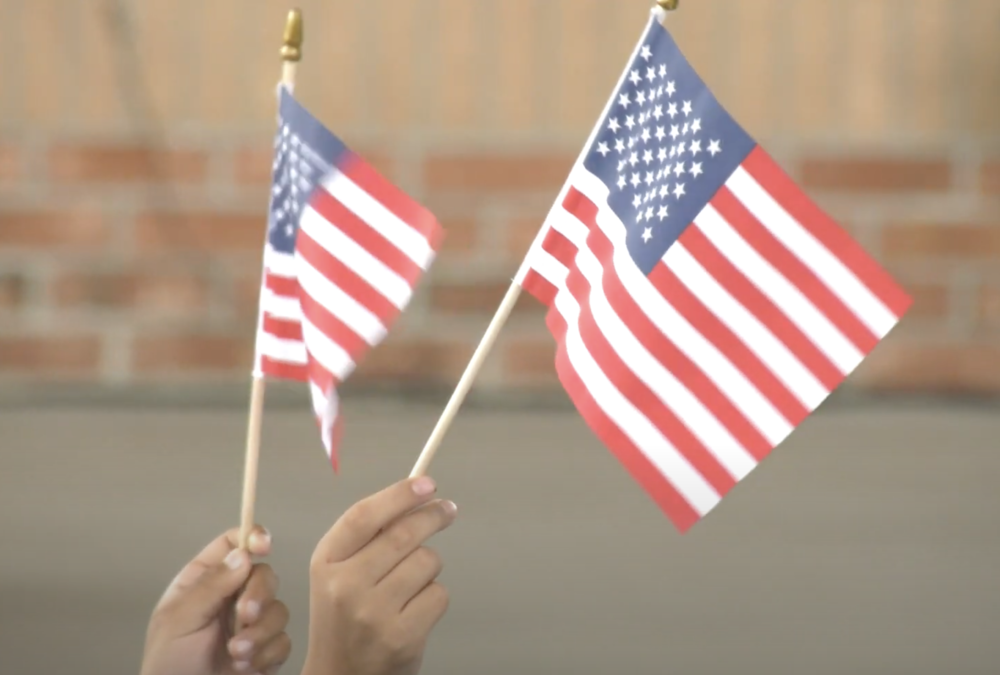 SeaWind Elementary students waive flags during Veteran's Day performance